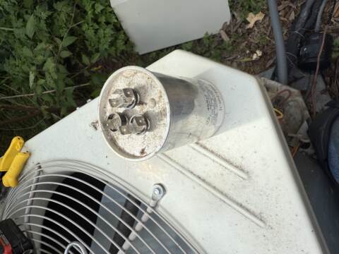 Failed dual capacitor removed from heat pump