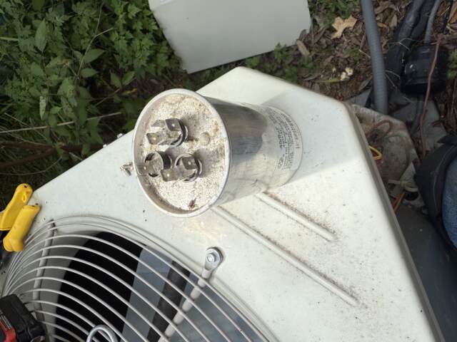 Failed dual capacitor removed from heat pump