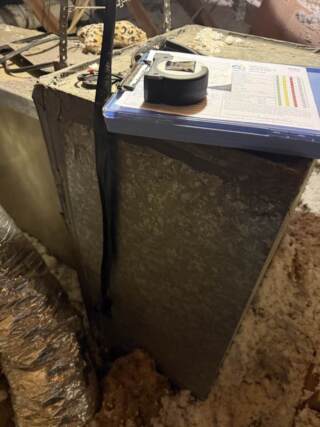 Clipboard with paper and tape measure getting measurements for new system