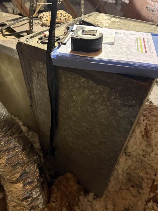 Clipboard with paper and tape measure getting measurements for new system