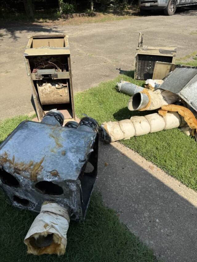 Old equipment removed from attic laying in yard ready to be hauled away