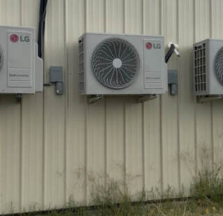 Three LG ductless mini splits hanging on the wall