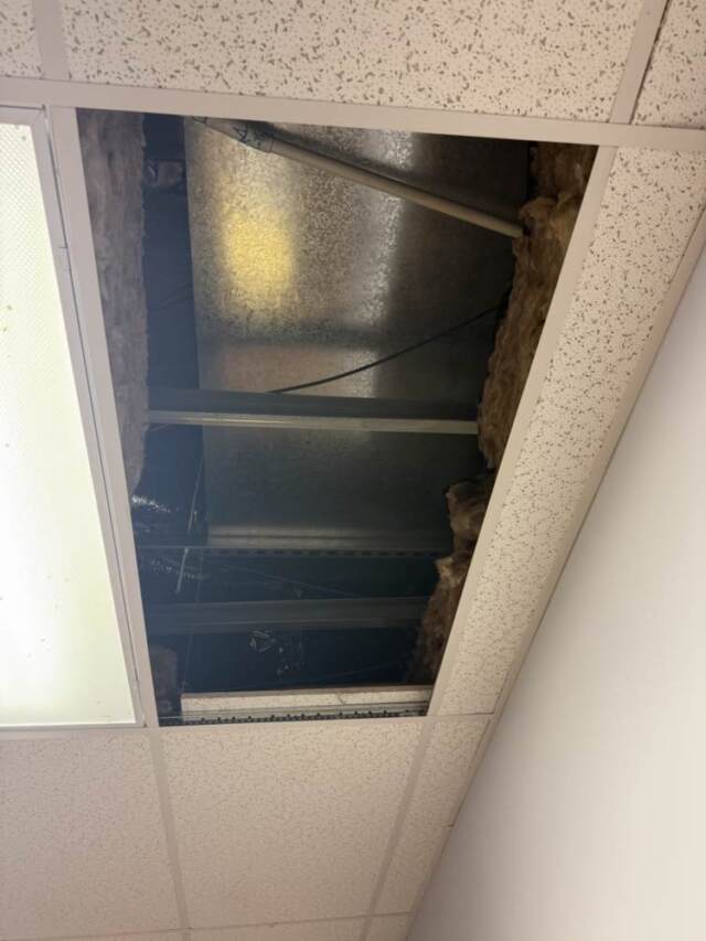 The indoor unit stuffed up in the attic above commercial ceiling tiles