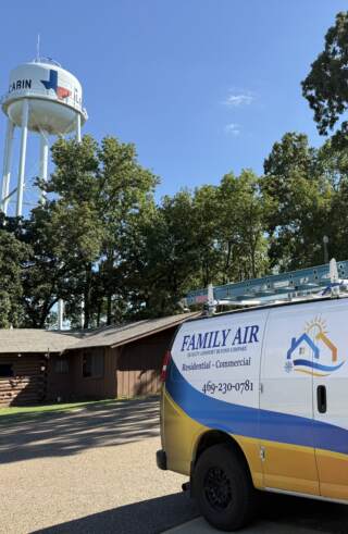Van in front of city hall at log cabin texas
