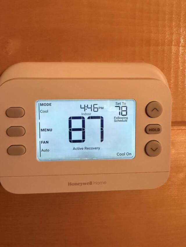 New thermostat on the wall and lit up when touched