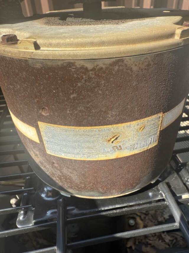 Old overheated rusty condenser fan motor