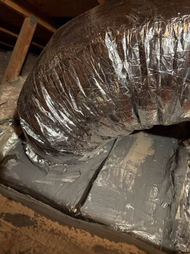 Picture of new duct on and showing the unit has been air sealed with mastic
