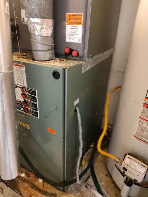 This shows the gas heater and water heater both inside a closet