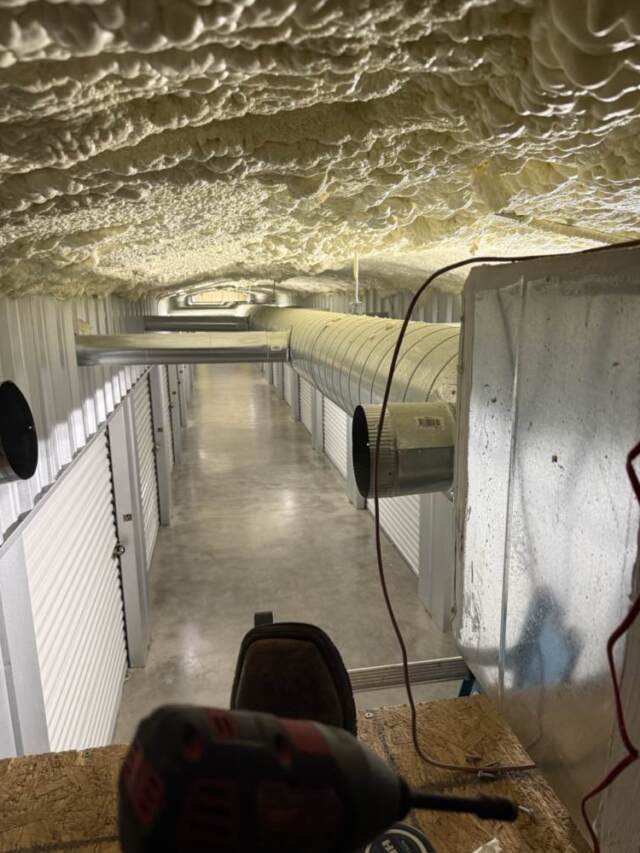 A look from up in the attic looking down the corrider at all the metal duct going to each storage room