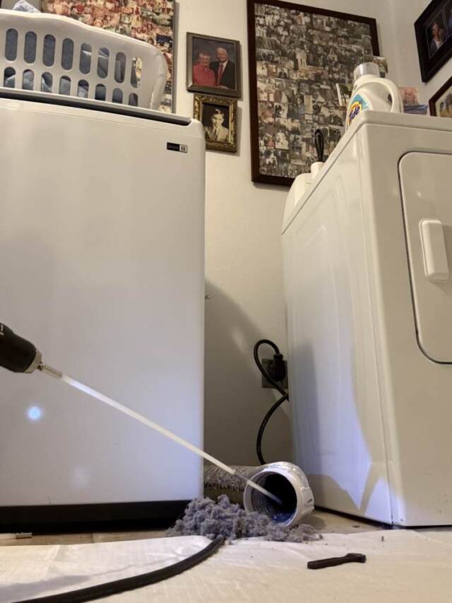 Dryer vent cleaning brush is inserted in the dryer hose and it is cleaning it out.