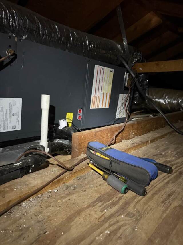 Airhandler lying on its side in a small attic space.