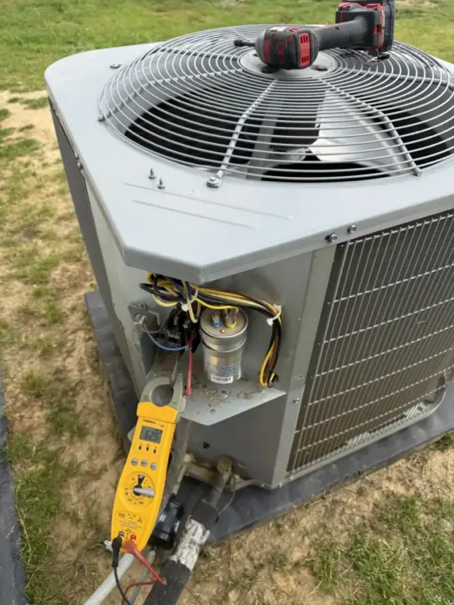 looking at the condenser with the electrical cover off and amp meter recording amperage.