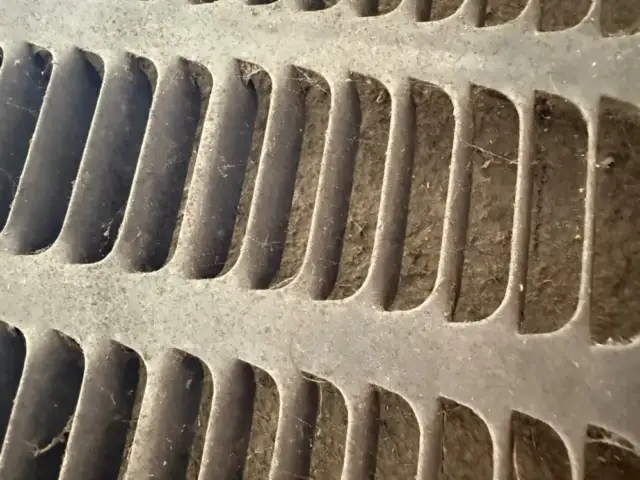 behind the metal louvers is the coil which you can see if completely covered in dirt and hair