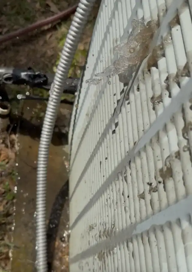 Washing the dirt out of the coil from inside out.
