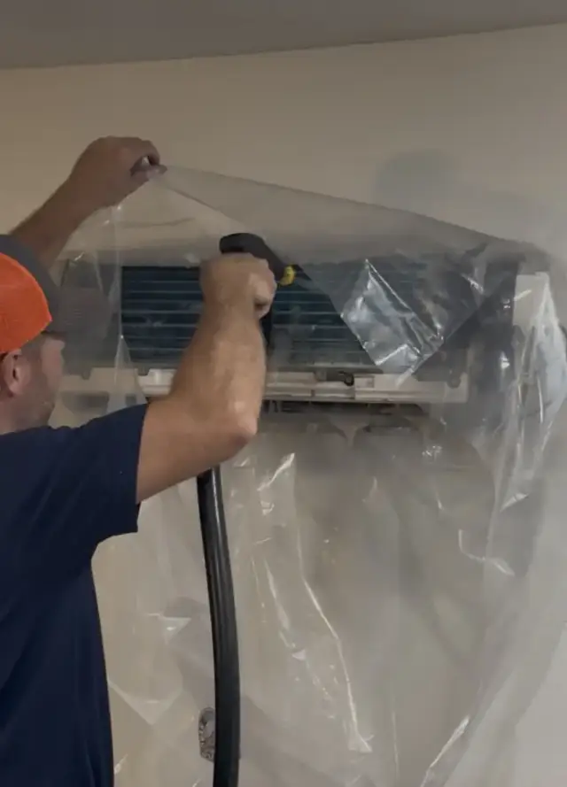 Using a specialized mini split sprayer to clean everything.