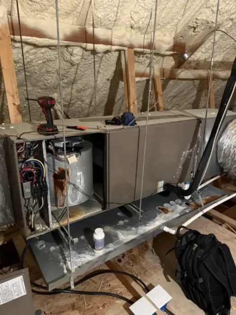 Checking components inside the unit in attic.