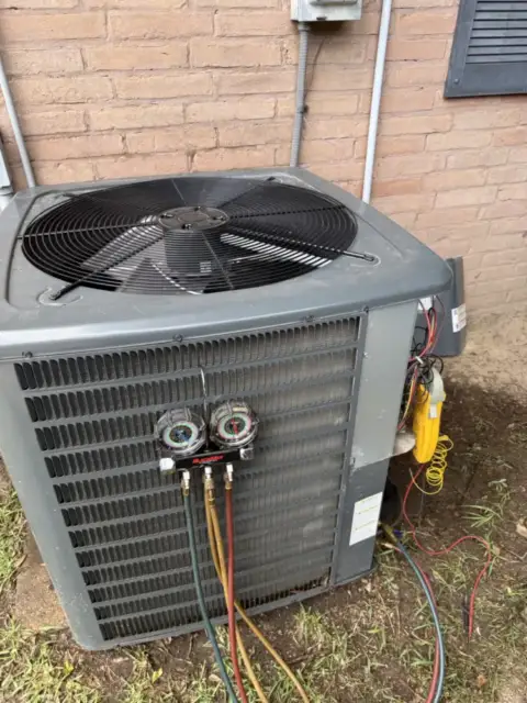 Gauges connected to the refrigerant ports and electrical meter taking amp draws.