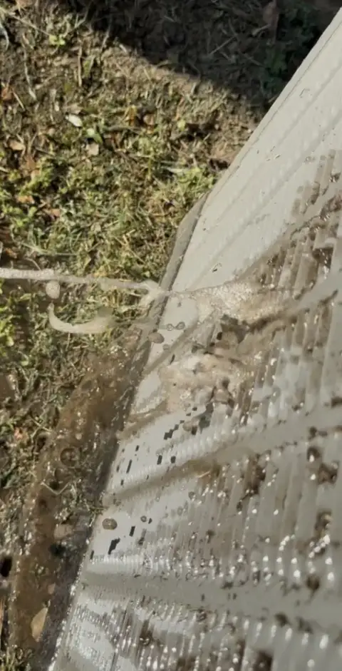 washing dirt off the condenser coil from the inside out.